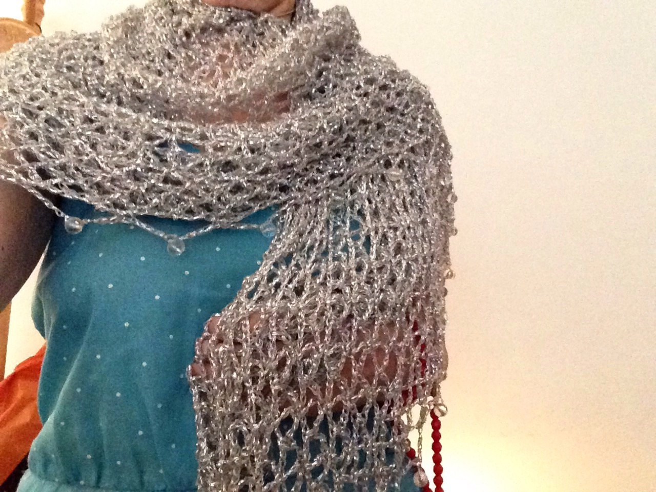 Silver shawl draped to show how it falls over the shoulders.