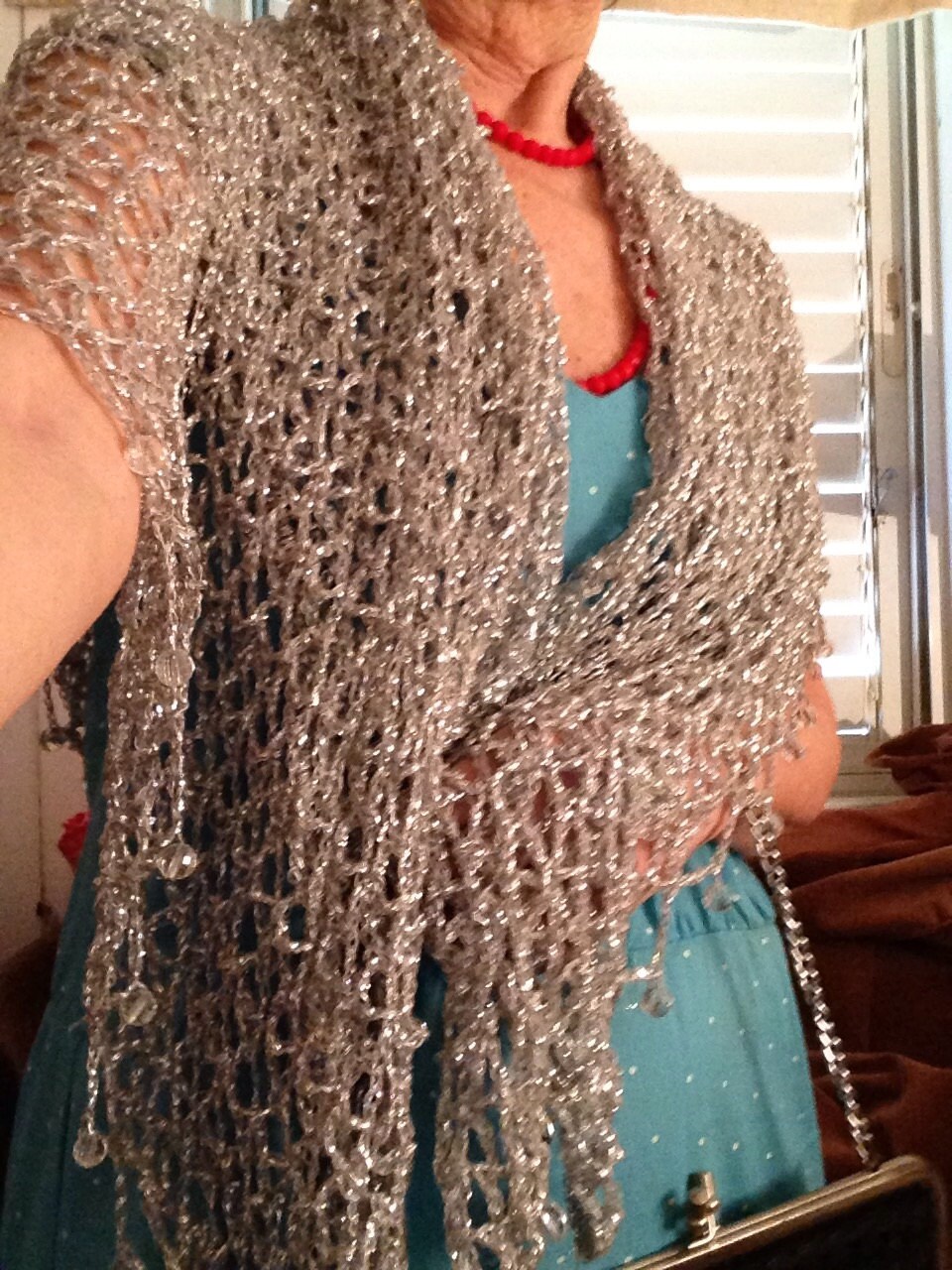 Side view of the silver shawl, the shimmering thread catching the light.
