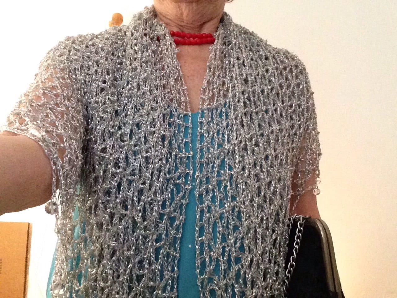 Detail of the hand stitches along the beaded edge of the silver shawl.
