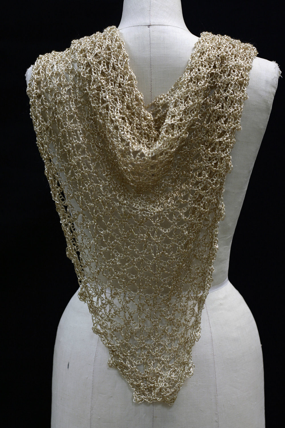 Close-up of the gold crochet openwork and beaded edge of the shawl.