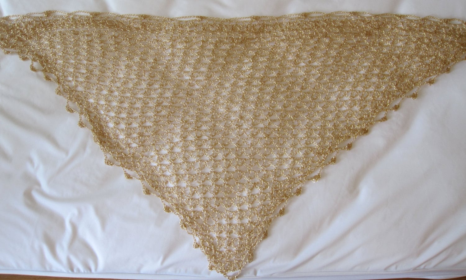 Gold shawl draped to show how it falls over the shoulders.