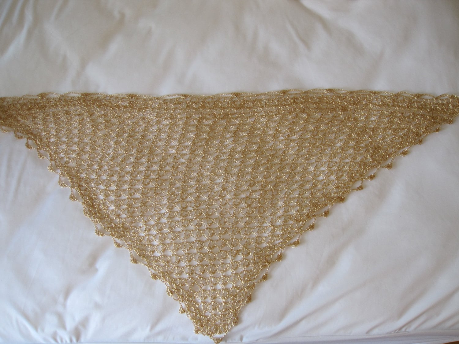 Side view of the gold shawl, the shimmering thread catching the light.